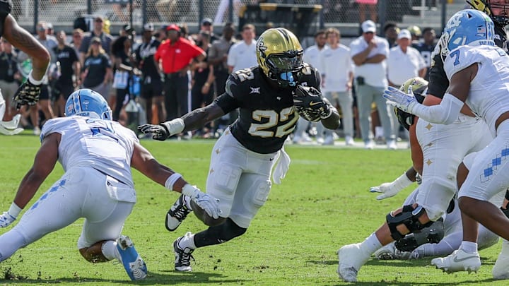 Sep 20, 2025; Orlando, Florida, USA; UCF Knights running back Myles Montgomery (22) carries the ball during the first quarter against the North Carolina Tar Heels at the Bounce House Stadium. Mandatory Credit: Mike Watters-Imagn Images
