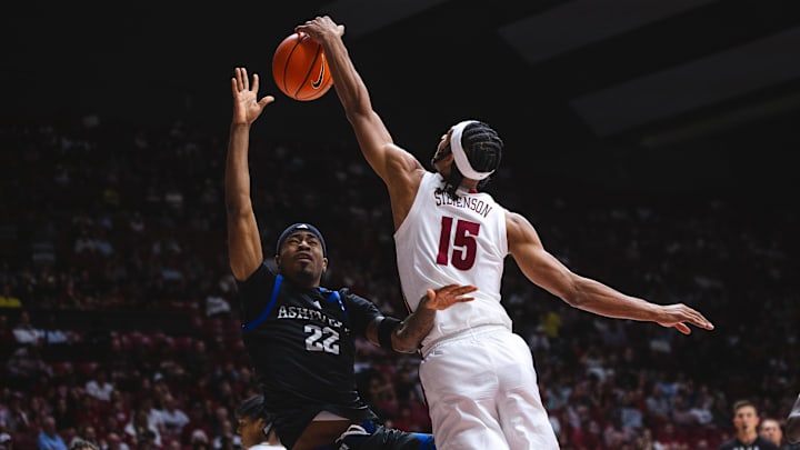 Nov 4, 2024; Tuscaloosa, Alabama, USA; Alabama Crimson Tide forward Jarin Stevenson (15) blocks a shot by North Carolina-Asheville Bulldogs guard Javoy Thompson (22) during the second half at Coleman Coliseum. 