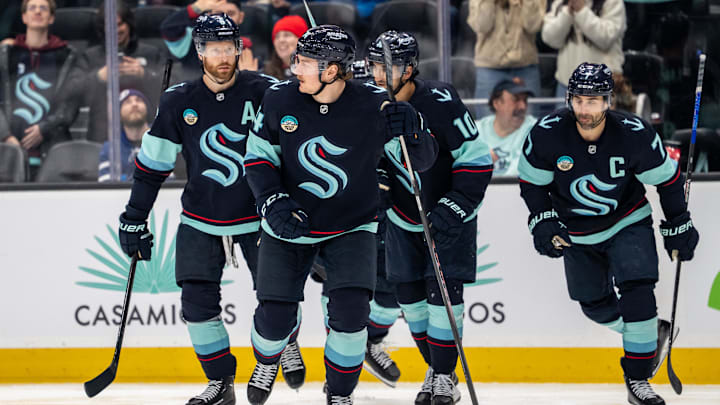 Mar 17, 2026; Seattle, Washington, USA; Seattle Kraken forward Bobby McMann (74), second from left, skates off the ice with defenseman Adam Larsson (6), left, forward Matty Beniers (10), and forward Jordan Eberle (7) after scoring a goal during the second period against the Tampa Bay Lightning at Climate Pledge Arena. Mandatory Credit: Stephen Brashear-Imagn Images