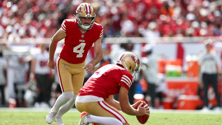 Nov 10, 2024; Tampa, Florida, USA; San Francisco 49ers place kicker Jake Moody (4) kicks a field goal held by punter Mitch Wishnowsky (3) against the Tampa Bay Buccaneers in the second quarter at Raymond James Stadium.