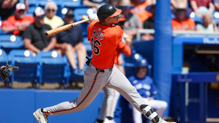 Mar 13, 2025; Dunedin, Florida, USA; Baltimore Orioles third baseman Coby Mayo (16) doubles against the Toronto Blue Jays in the second inning during spring training at TD Ballpark. 