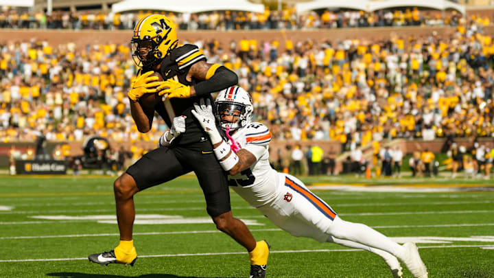 Oct 19, 2024; Columbia, Missouri, USA; Missouri Tigers wide receiver Theo Wease Jr. (1) is tackled by Auburn Tigers cornerback Jay Crawford (23) during the second half at Faurot Field at Memorial Stadium. Mandatory Credit: Jay Biggerstaff-Imagn Images
