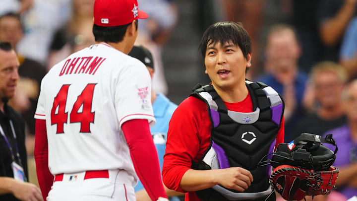 Jul 12, 2021; Denver, CO, USA; Los Angeles Angels designated hitter/starting pitcher Shohei Ohtani speaks with interpreter Ippei Mizuhara during the 2021 MLB Home Run Derby. Mandatory Credit: Mark J. Rebilas-Imagn Images