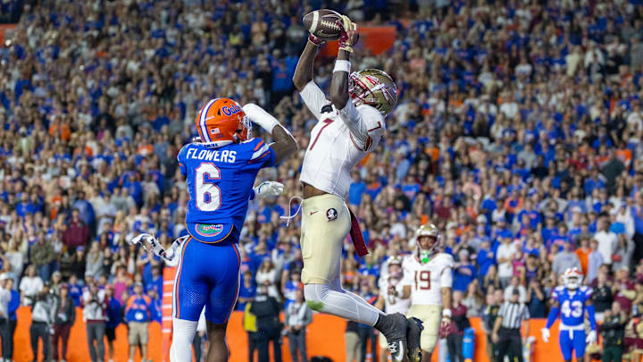 Nov 29, 2025; Gainesville, Florida, USA; Florida State Seminoles wide receiver Lawayne McCoy (7) scores a touchdown during the fourth quarter against the Florida Gators at Ben Hill Griffin Stadium. Mandatory Credit: Bob Kupbens-Imagn Images