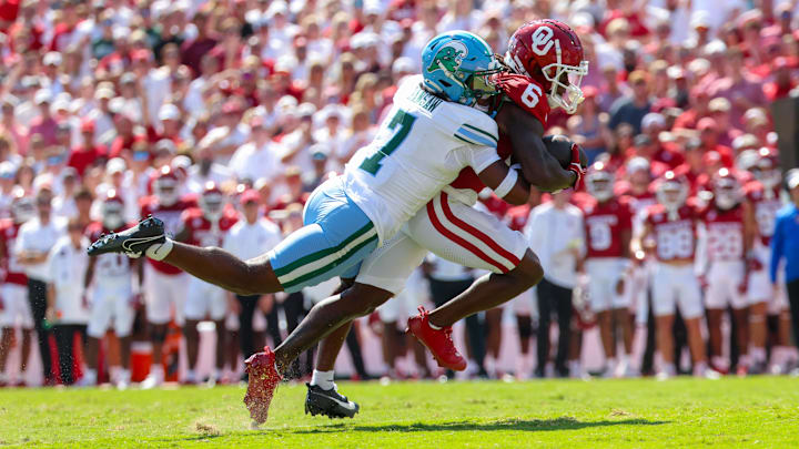 Oklahoma Sooners wide receiver Deion Burks runs with the ball during this season's contest against the Tulane Green Wave. Oklahoma Sooners wide receiver Deion Burks runs with the ball during this season's contest against the Tulane Green Wave.
