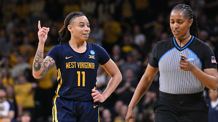 Mar 25, 2024; Iowa City, IA, USA; West Virginia Mountaineers guard JJ Quinerly (11) talks with an official during the fourth quarter against the Iowa Hawkeyes in the NCAA second round game at Carver-Hawkeye Arena. Mandatory Credit: Jeffrey Becker-Imagn Images