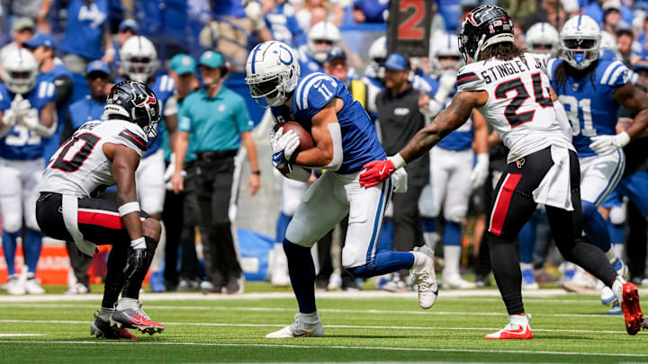 Indianapolis Colts wide receiver Michael Pittman Jr. (11) looks to move past Houston Texans safety Jimmie Ward (20) and Houston Texans cornerback Derek Stingley Jr. (24) on Sunday, Sept. 8, 2024, during a game against the Houston Texans at Lucas Oil Stadium in Indianapolis.