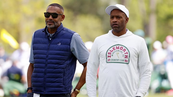 Former NBA players Grant Hill and Vince Carter look on during the first round of the Masters Tournament.