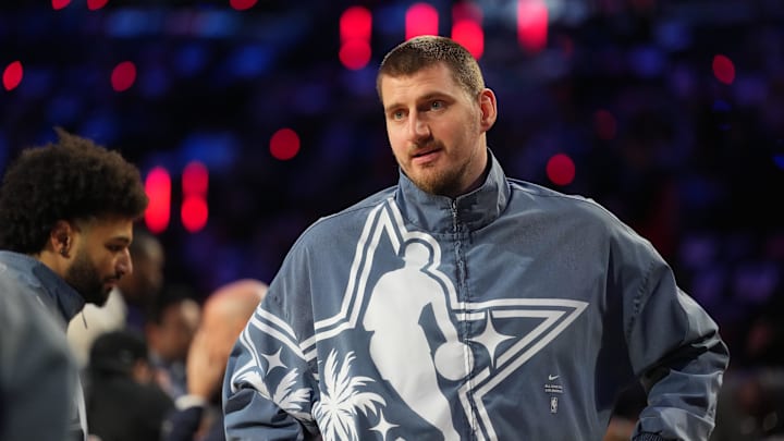 Feb 15, 2026; Inglewood, California, USA; Team World center Nikola Jokic (15) of the Denver Nuggets looks on before game 1 during the 75th NBA All Star Game at Intuit Dome. Mandatory Credit: Kirby Lee-Imagn Images Feb 15, 2026; Inglewood, California, USA; Team World center Nikola Jokic (15) of the Denver Nuggets looks on before game 1 during the 75th NBA All Star Game at Intuit Dome. Mandatory Credit: Kirby Lee-Imagn Images