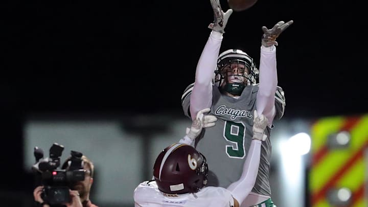 Lake Catholic tight end Cross Nimmo, top, can't hang onto a pass in the end zone against Walsh Jesuit defensive back Brayden Foster during the first half of a high school football game, Friday, Oct. 13, 2023, in Mentor, Ohio.