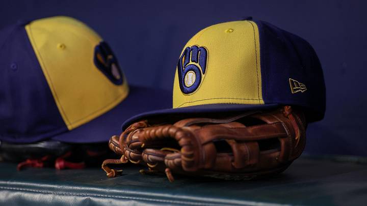 Jul 28, 2023; Atlanta, Georgia, USA; A detailed view of a Milwaukee Brewers hat and glove on the bench against the Atlanta Braves in the second inning at Truist Park. Mandatory Credit: Brett Davis-Imagn Images