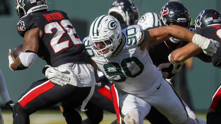 Green Bay Packers defensive end Lukas Van Ness (90) tackles Houston Texans running back Joe Mixon.