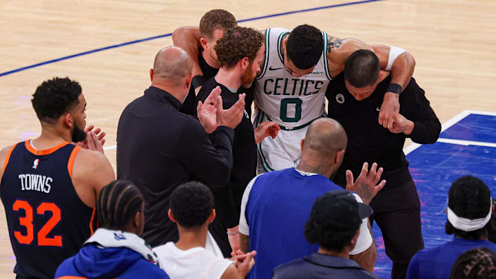 May 12, 2025; New York, New York, USA: Boston Celtics forward Jayson Tatum (0) is helped off the court by after an injury in the second half during game four of the second round for the 2025 NBA Playoffs against the New York Knicks at Madison Square Garden. Tatum would leave the game with an injury after this play. Mandatory Credit: Vincent Carchietta-Imagn Images May 12, 2025; New York, New York, USA: Boston Celtics forward Jayson Tatum (0) is helped off the court by after an injury in the second half during game four of the second round for the 2025 NBA Playoffs against the New York Knicks at Madison Square Garden. Tatum would leave the game with an injury after this play. Mandatory Credit: Vincent Carchietta-Imagn Images