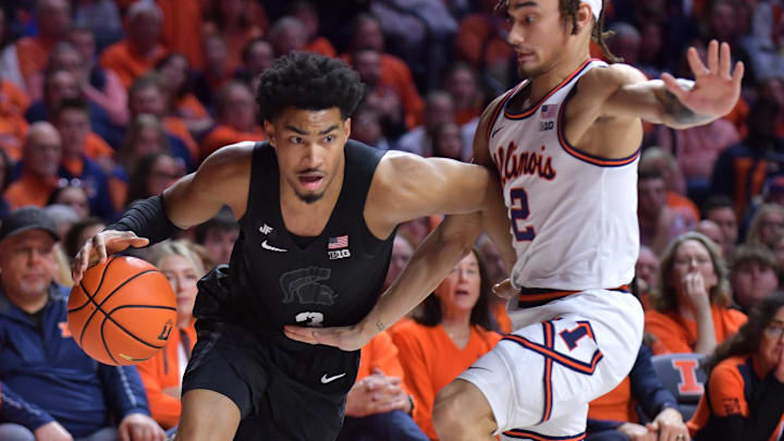 Feb 15, 2025; Champaign, Illinois, USA;  Michigan State Spartans guard Jaden Akins (3) drives the ball past Illinois Fighting Illini guard Dra Gibbs-Lawhorn (2) during the second half at State Farm Center. Mandatory Credit: Ron Johnson-Imagn Images