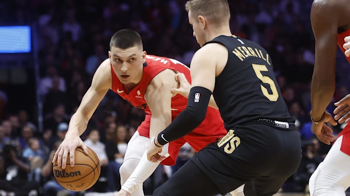 Dec 8, 2024; Miami, Florida, USA;  Cleveland Cavaliers guard Sam Merrill (5) defends Miami Heat guard Tyler Herro (14) during the second half at Kaseya Center. Mandatory Credit: Rhona Wise-Imagn Images