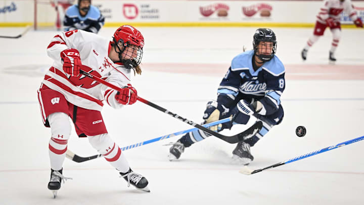 Wisconsin center Adela Sapovalivova (26) shoots the puck during the first period of a game against Maine on Friday, October 3, 2025, at LaBahn Arena in Madison, Wisconsin.