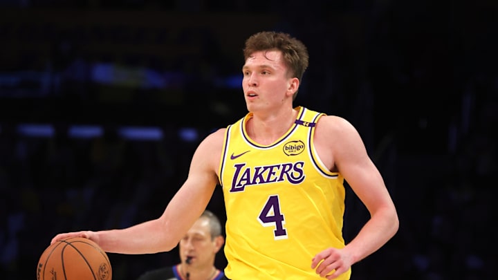 Oct 22, 2024; Los Angeles, California, USA; Los Angeles Lakers guard Dalton Knecht (4) dribbles during the second quarter against the Minnesota Timberwolves at Crypto.com Arena. Mandatory Credit: Jason Parkhurst-Imagn Images