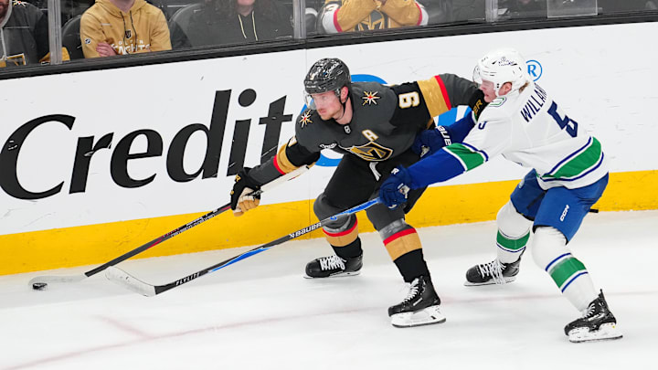 Feb 4, 2026; Las Vegas, Nevada, USA; Vegas Golden Knights center Jack Eichel (9) keeps the puck away from Vancouver Canucks defenseman Tom Willander (5) during the third period at T-Mobile Arena. Mandatory Credit: Stephen R. Sylvanie-Imagn Images