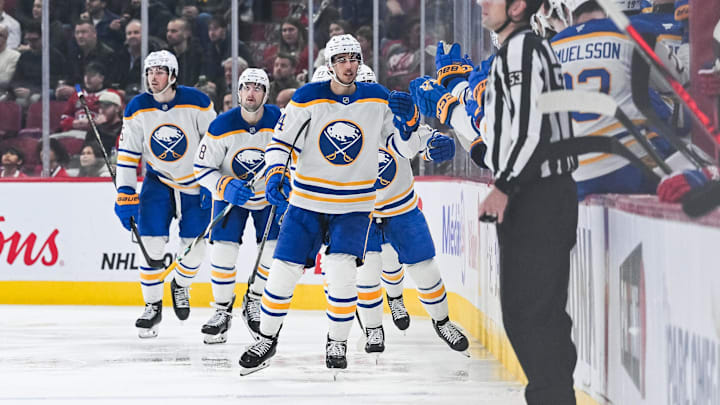 Dec 17, 2024; Montreal, Quebec, CAN; Buffalo Sabres center Dylan Cozens (24) celebrates his goal with his teammates at the bench against the Montreal Canadiens during the second period at Bell Centre. Mandatory Credit: David Kirouac-Imagn Images