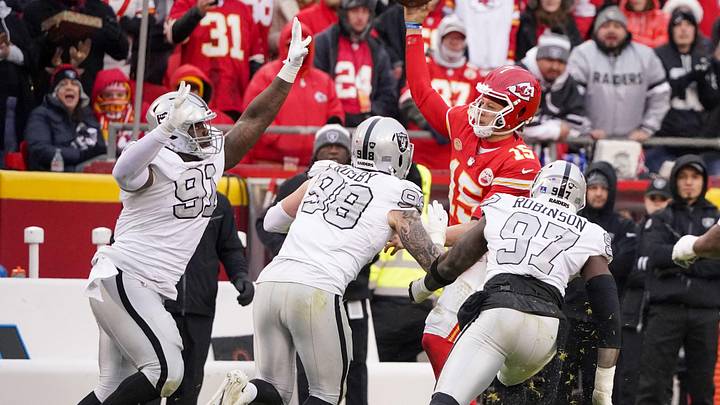 Dec 25, 2023; Kansas City, Missouri, USA; Kansas City Chiefs quarterback Patrick Mahomes (15) throws a pass as he   s pressured by Las Vegas Raiders defensive tackle Bilal Nichols (91) and defensive end Maxx Crosby (98) and defensive end Janarius Robinson (97) during the game at GEHA Field at Arrowhead Stadium. Mandatory Credit: Denny Medley-USA TODAY Sports