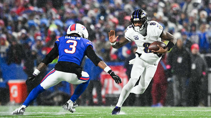 Baltimore Ravens quarterback Lamar Jackson runs the ball against Buffalo Bills safety Damar Hamlin