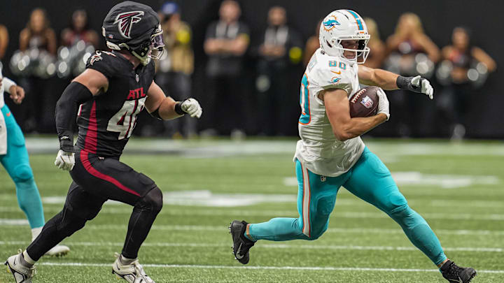 Miami Dolphins tight end Tanner Conner (80) runs against Atlanta Falcons linebacker JD Bertrand (40) during the second half at Mercedes-Benz Stadium.