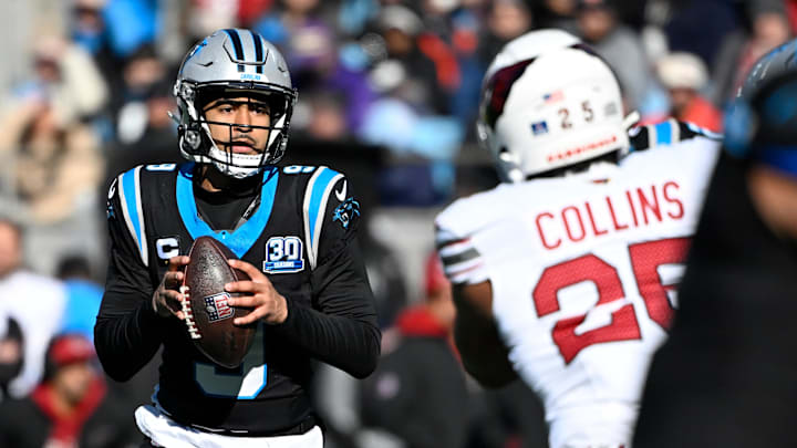 Dec 22, 2024; Charlotte, North Carolina, USA; Carolina Panthers quarterback Bryce Young (9) looks to pass as Arizona Cardinals linebacker Zaven Collins (25) defends in the first quarter at Bank of America Stadium. Mandatory Credit: Bob Donnan-Imagn Images