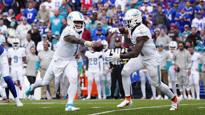Nov 3, 2024; Orchard Park, New York, USA; Miami Dolphins quarterback Tua Tagovailoa (1) hands off the ball to Miami Dolphins running back Raheem Mostert (31) during the second half against the Buffalo Bills at Highmark Stadium.