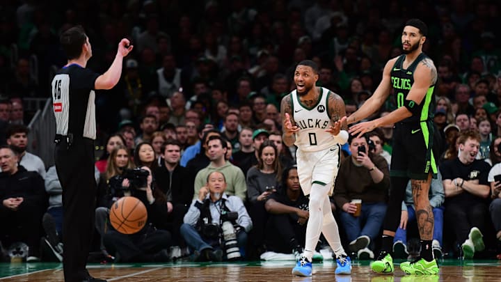 Dec 6, 2024; Boston, Massachusetts, USA;  Milwaukee Bucks guard Damian Lillard (0) reacts after fouling Boston Celtics forward Jayson Tatum (0) during the second half at TD Garden. Mandatory Credit: Bob DeChiara-Imagn Images