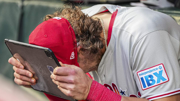 Apr 9, 2025; Cumberland, Georgia, USA; Philadelphia Phillies third base Alec Bohm (28) reacts in the dugout against the Atlanta Braves during the second inning at Truist Park.