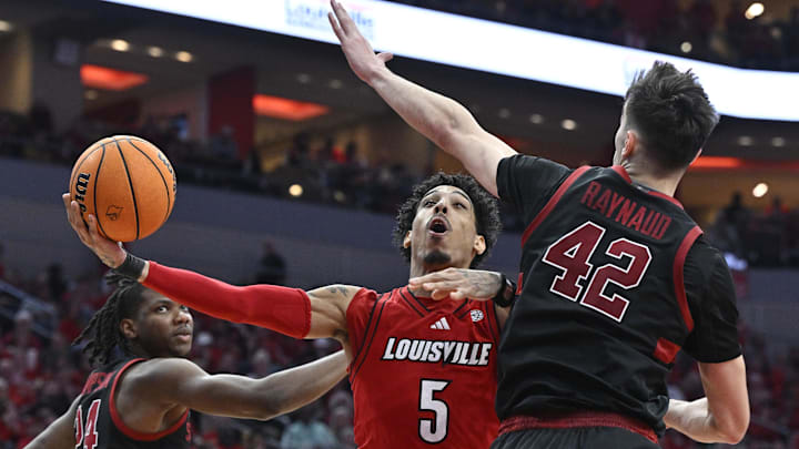 Mar 8, 2025; Louisville, Kentucky, USA; Louisville Cardinals guard Terrence Edwards Jr. (5) shoots against Stanford Cardinal forward Maxime Raynaud (42) and forward Jaylen Thompson (24) during the second half at KFC Yum! Center. Louisville defeated Stanford 68-48. Mandatory Credit: Jamie Rhodes-Imagn Images Mar 8, 2025; Louisville, Kentucky, USA; Louisville Cardinals guard Terrence Edwards Jr. (5) shoots against Stanford Cardinal forward Maxime Raynaud (42) and forward Jaylen Thompson (24) during the second half at KFC Yum! Center. Louisville defeated Stanford 68-48. Mandatory Credit: Jamie Rhodes-Imagn Images