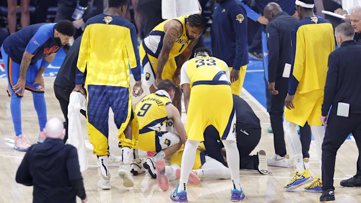 Jun 22, 2025; Oklahoma City, Oklahoma, USA; Indiana Pacers guard Tyrese Haliburton (0) is checked on after an apparent injury following a play against the Oklahoma City Thunder during the first half of game seven of the 2025 NBA Finals at Paycom Center. Mandatory Credit: Alonzo Adams-Imagn Images