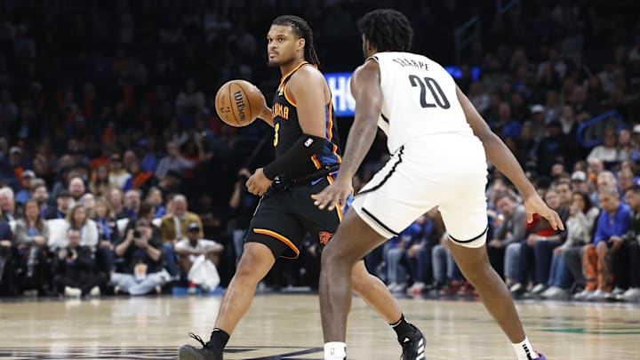 Jan 19, 2025; Oklahoma City, Oklahoma, USA; Oklahoma City Thunder forward Dillon Jones (3) dribbles the ball as Brooklyn Nets center Day'Ron Sharpe (20) defends during the second half at Paycom Center. Mandatory Credit: Alonzo Adams-Imagn Images