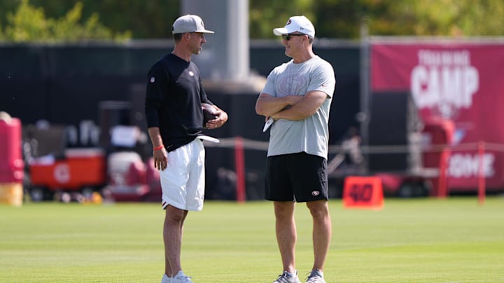 Jul 28, 2021; Santa Clara, CA, USA;  San Francisco 49ers head coach Kyle Shanahan (left) and general manager John Lynch during training camp at the SAP Performance Facility.  Mandatory Credit: Stan Szeto-Imagn Images