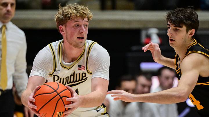 Purdue Boilermakers guard Jack Benter (14) looks to pass against Iowa Hawkeyes guard Tate Sage (24). Purdue Boilermakers guard Jack Benter (14) looks to pass against Iowa Hawkeyes guard Tate Sage (24).