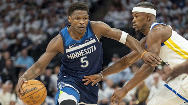 May 8, 2025; Minneapolis, Minnesota, USA; Minnesota Timberwolves guard Anthony Edwards (5) dribbles the ball past Golden State Warriors forward Jimmy Butler III (10) in the first half during game two of the second round for the 2025 NBA Playoffs at Target Center.
