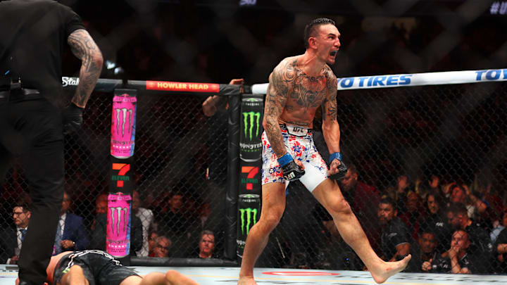 Apr 13, 2024; Las Vegas, Nevada, USA; Max Holloway (blue gloves) reacts after defeating Justin