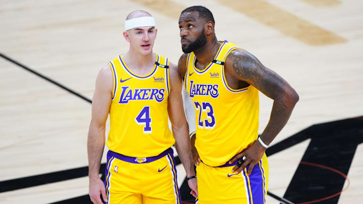 May 25, 2021; Phoenix, Arizona, USA; Los Angeles Lakers forward LeBron James (23) and guard Alex Caruso (4) against the Phoenix Suns during game two of the first round of the 2021 NBA Playoffs at Phoenix Suns Arena. Mandatory Credit: Mark J. Rebilas-Imagn Images