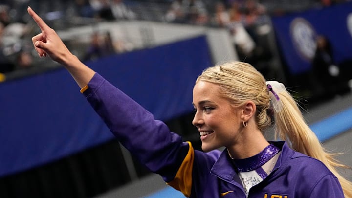 LSU gymnast LSU gymnast Livvy Dunne walks with teammates to a competition area and gestures to fans during Session 2 of the SEC Gymnastics Championship at Legacy Arena in Birmingham, Alabama. LSU won the event to claim the SEC crown.