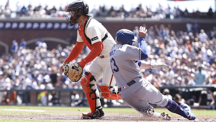 Apr 23, 2026; San Francisco, California, USA; Los Angeles Dodgers third baseman Max Muncy (13) scores a run against San Francisco Giants catcher Patrick Bailey (14) during the second inning at Oracle Park. Mandatory Credit: Kelley L Cox-Imagn Images