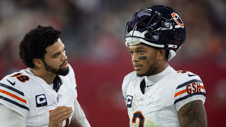 Nov 3, 2024; Glendale, Arizona, USA; Chicago Bears quarterback Caleb Williams (18) talks with wide receiver DJ Moore (2) against the Arizona Cardinals at State Farm Stadium. Nov 3, 2024; Glendale, Arizona, USA; Chicago Bears quarterback Caleb Williams (18) talks with wide receiver DJ Moore (2) against the Arizona Cardinals at State Farm Stadium.