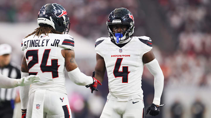 Sep 15, 2025; Houston, Texas, USA; Houston Texans cornerback Kamari Lassiter (4) celebrates with Houston Texans cornerback Derek Stingley Jr. (24) after making a stop during the second quarter at NRG Stadium. Mandatory Credit: Troy Taormina-Imagn Images