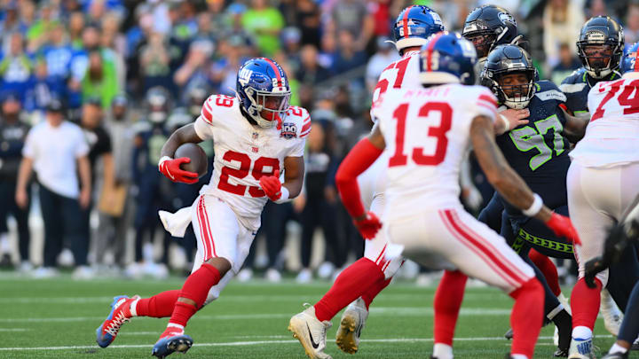 Oct 6, 2024; Seattle, Washington, USA; New York Giants running back Tyrone Tracy Jr. (29) carries the ball against the Seattle Seahawks during the second half at Lumen Field.  