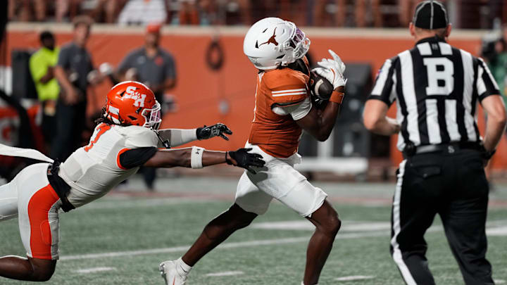 Sep 20, 2025; Austin, Texas, USA; Texas Longhorns wide receiver Ryan Wingo (1) catches a pass for a touchdown over Sam Houston Bearkats linebacker Emon Allen (7) during the second half at Darrell K Royal-Texas Memorial Stadium. Mandatory Credit: Scott Wachter-Imagn Images