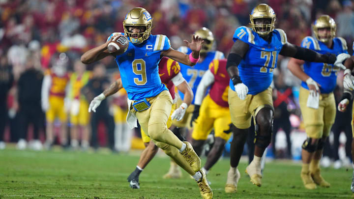 Nov 29, 2025; Los Angeles, California, USA; UCLA Bruins quarterback Nico Iamaleava (9) carries the ball against the Southern California Trojans in the first half at United Airlines Field at Los Angeles Memorial Coliseum. Mandatory Credit: Kirby Lee-Imagn Images Nov 29, 2025; Los Angeles, California, USA; UCLA Bruins quarterback Nico Iamaleava (9) carries the ball against the Southern California Trojans in the first half at United Airlines Field at Los Angeles Memorial Coliseum. Mandatory Credit: Kirby Lee-Imagn Images