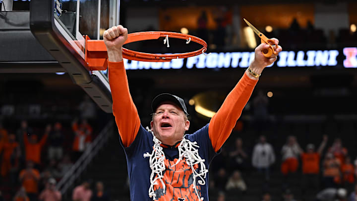Mar 28, 2026; Houston, TX, USA; Illinois Fighting Illini head coach Brad Underwood celebrates after cutting down the net after defeating the Iowa Hawkeyes in an Elite Eight game of the South Regional of the men's 2026 NCAA Tournament at Toyota Center.