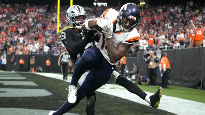 Nov 24, 2024; Paradise, Nevada, USA; Denver Broncos wide receiver Courtland Sutton (14) catches an 18-yard touchdown pass against Las Vegas Raiders cornerback Jack Jones (18) in the third quarter at Allegiant Stadium. Nov 24, 2024; Paradise, Nevada, USA; Denver Broncos wide receiver Courtland Sutton (14) catches an 18-yard touchdown pass against Las Vegas Raiders cornerback Jack Jones (18) in the third quarter at Allegiant Stadium.