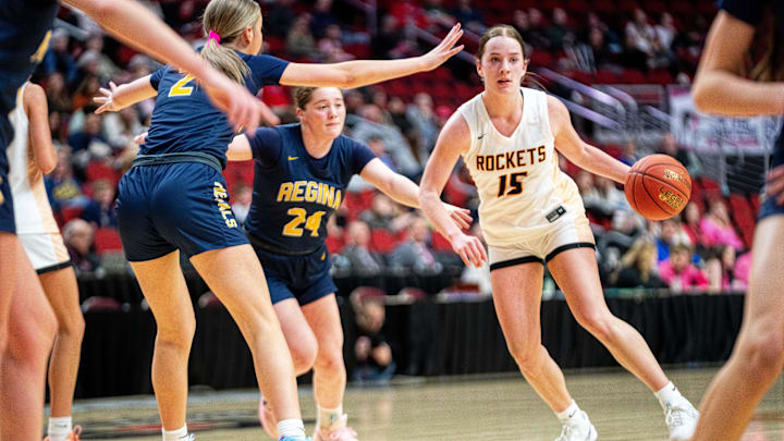 Rock Valley's Haevyn Ranschau (15) drives past her defender, Regina Catholic's Addie McLaughlin (24), on March 4, 2026, at Casey’s Center in Des Moines.