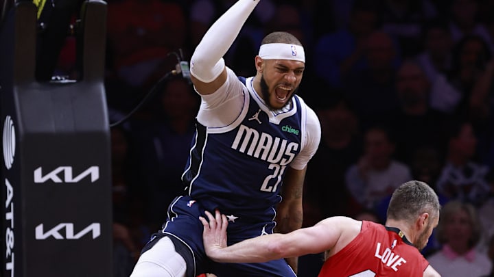 Nov 24, 2024; Miami, Florida, USA;  Dallas Mavericks center Daniel Gafford (21) reacts after a dunk over Miami Heat forward Kevin Love (42) during the first half  at Kaseya Center. Mandatory Credit: Rhona Wise-Imagn Images