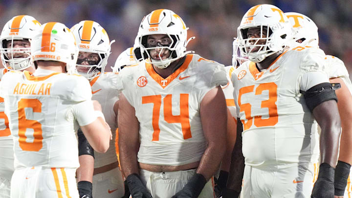 Tennessee offensive lineman Shamurad Umarov (74) and Tennessee offensive lineman Lance Heard (53) huddle with teammates as they listen to Tennessee quarterback Joey Aguilar (6) during a college football game between Tennessee and Florida at Ben Hill Griffin Stadium in Gainesville, Florida., on Nov. 22, 2025.